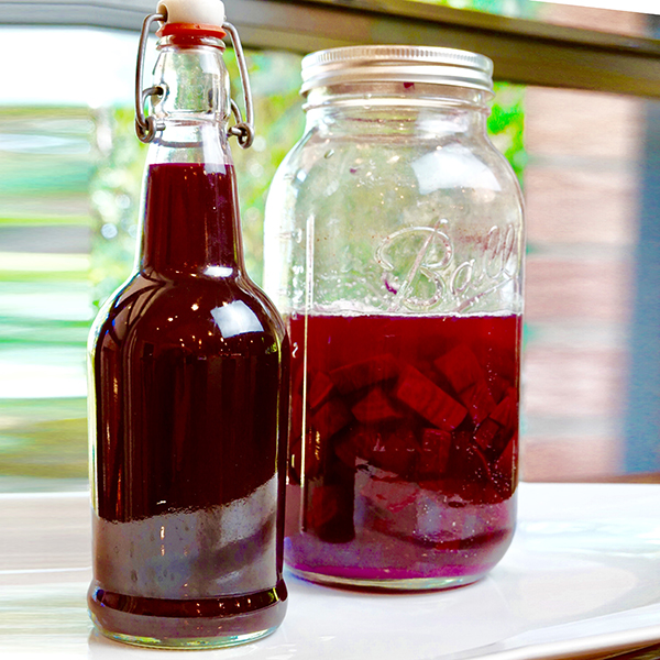 jar and bottle of fermented beet kvass