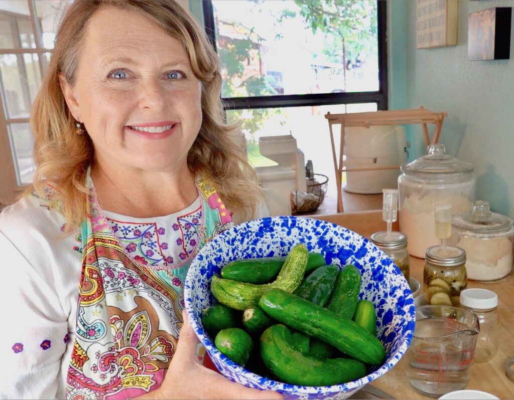 caren holding a bowl of freshly picked cucumbers