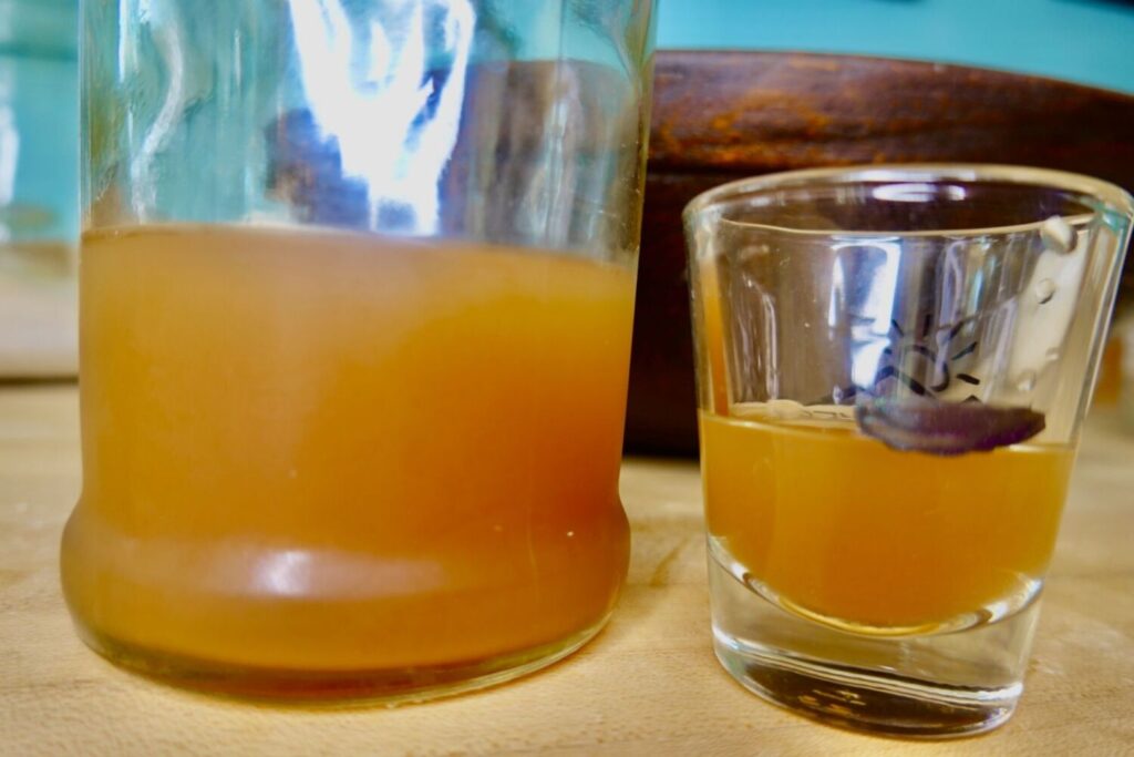 master tonic in a bottle and glass with measurement marking