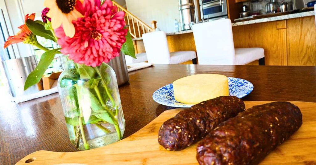 beef summer sausage without nitrates with homemade cheese and fresh flowers