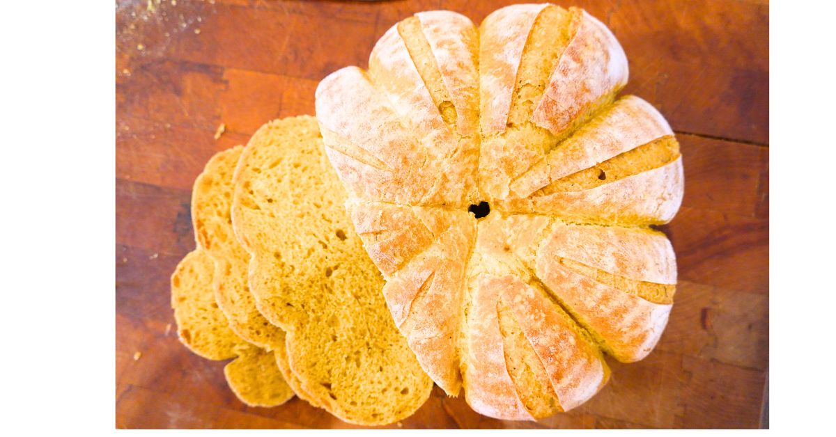 Pumpkin shaped sourdough bread sliced showing the color of the bread