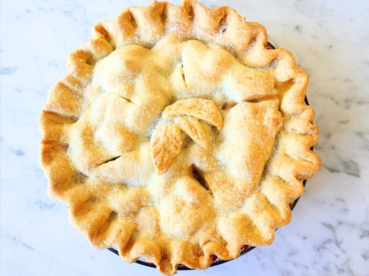 whole apple pie with a butter crust and leaves made our of pie crust